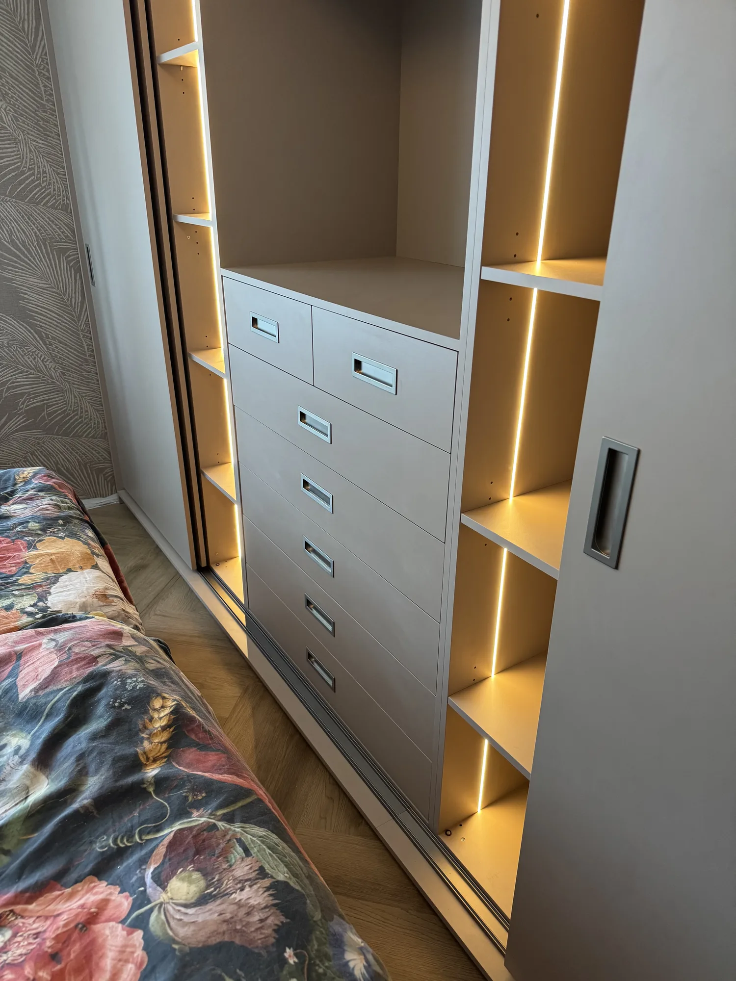 Detail van de laden in de schuifdeurkast, met een ledstrip langs de open vakken